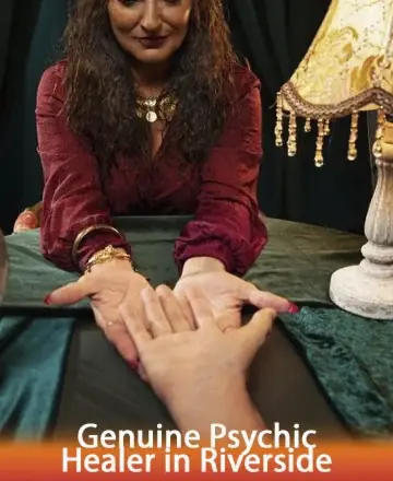 In the comforting glow of a warmly lit room, a serene guide reaches out with gentle hands, inviting trust and offering wisdom. The atmosphere is filled with peace and understanding, promising a journey towards inner clarity. Psychic reading in Riverside.