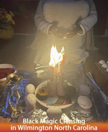 In a serene setting, soft candlelight flickers gently, creating a warm glow that envelops the space in tranquility. A sense of calm and gentle assurance fills the room, inviting peace and clarity into the heart. Black magic cleansing in Wilmington North Carolina.
