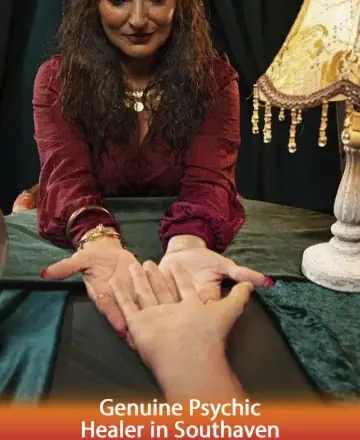 In a serene, warmly lit room, a compassionate guide gently cradles your hand, inviting trust and understanding. Her presence exudes wisdom and calm, enveloping you in a cocoon of peace and insight. Genuine psychic healer in Southaven.