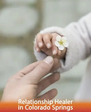 A tender moment captured in time, where the gentle exchange of a delicate flower speaks of trust and connection. The soft touch of hands symbolizes the nurturing of relationships, offering peace and harmony. Relationship healer in Colorado Springs.