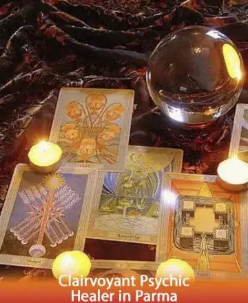 In a serene, softly lit space, tarot cards spread gracefully under the gentle glow of candlelight. A crystal ball rests nearby, inviting reflection and insight. This peaceful setting offers a sanctuary for the soul, embracing you in warmth and wisdom. Clairvoyant psychic healer in Parma.